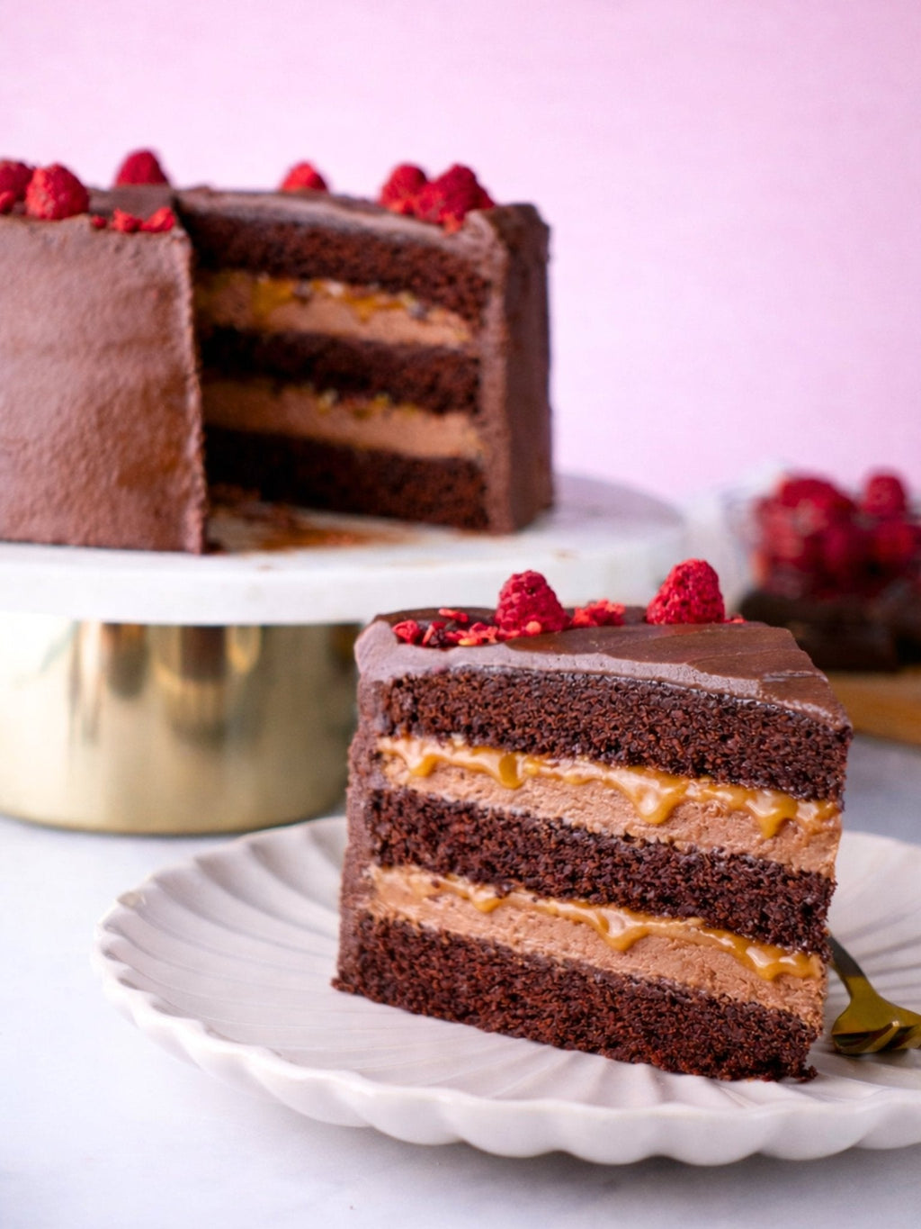 Patisserie Valerie's handmade Chocolate Fudge Cake being decorated, sliced and served