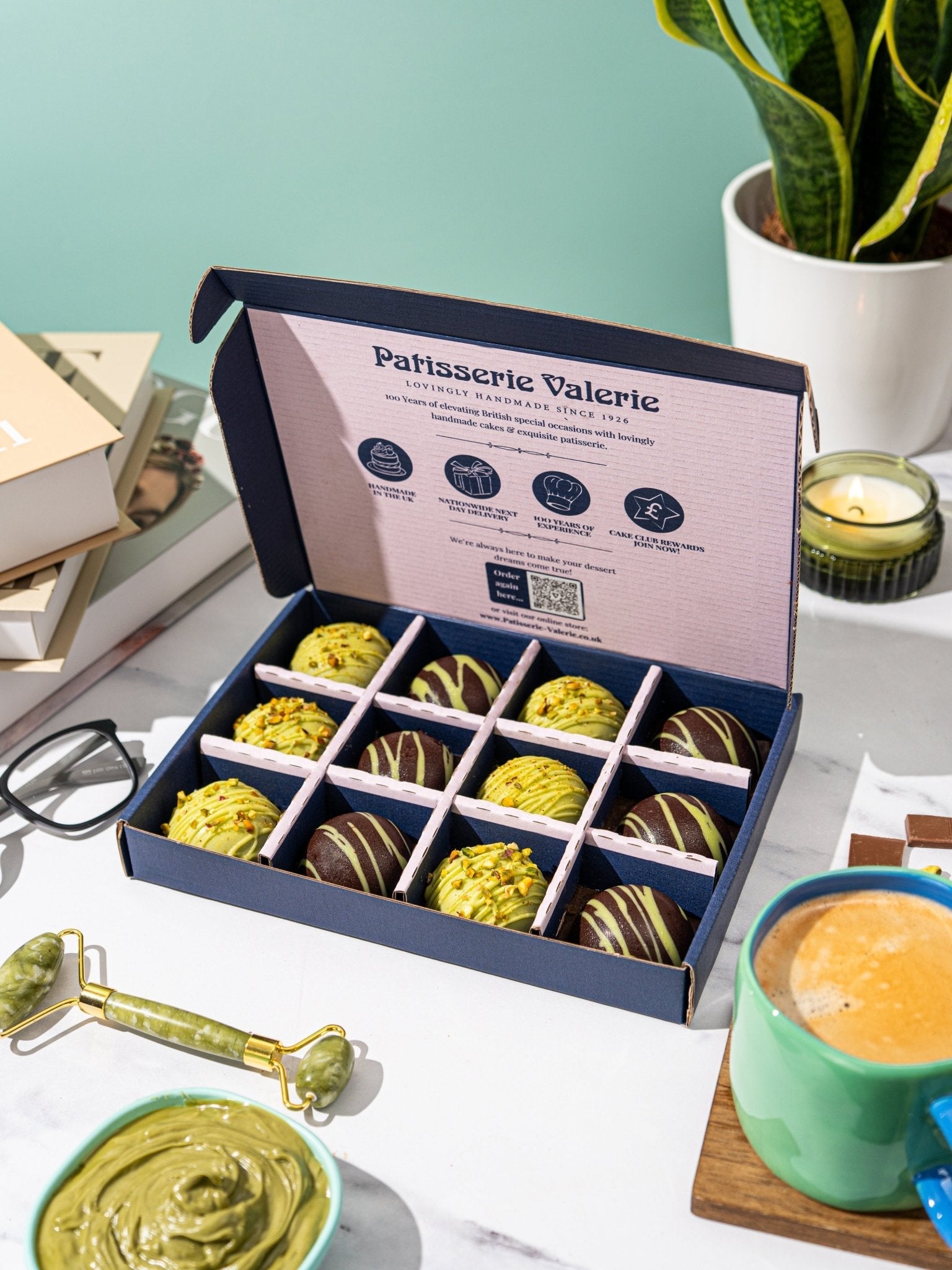 Patisserie Valerie's handmade Dubai-Style Chocolate & Pistachio Bites unboxed and cut open to show the pistachio filling