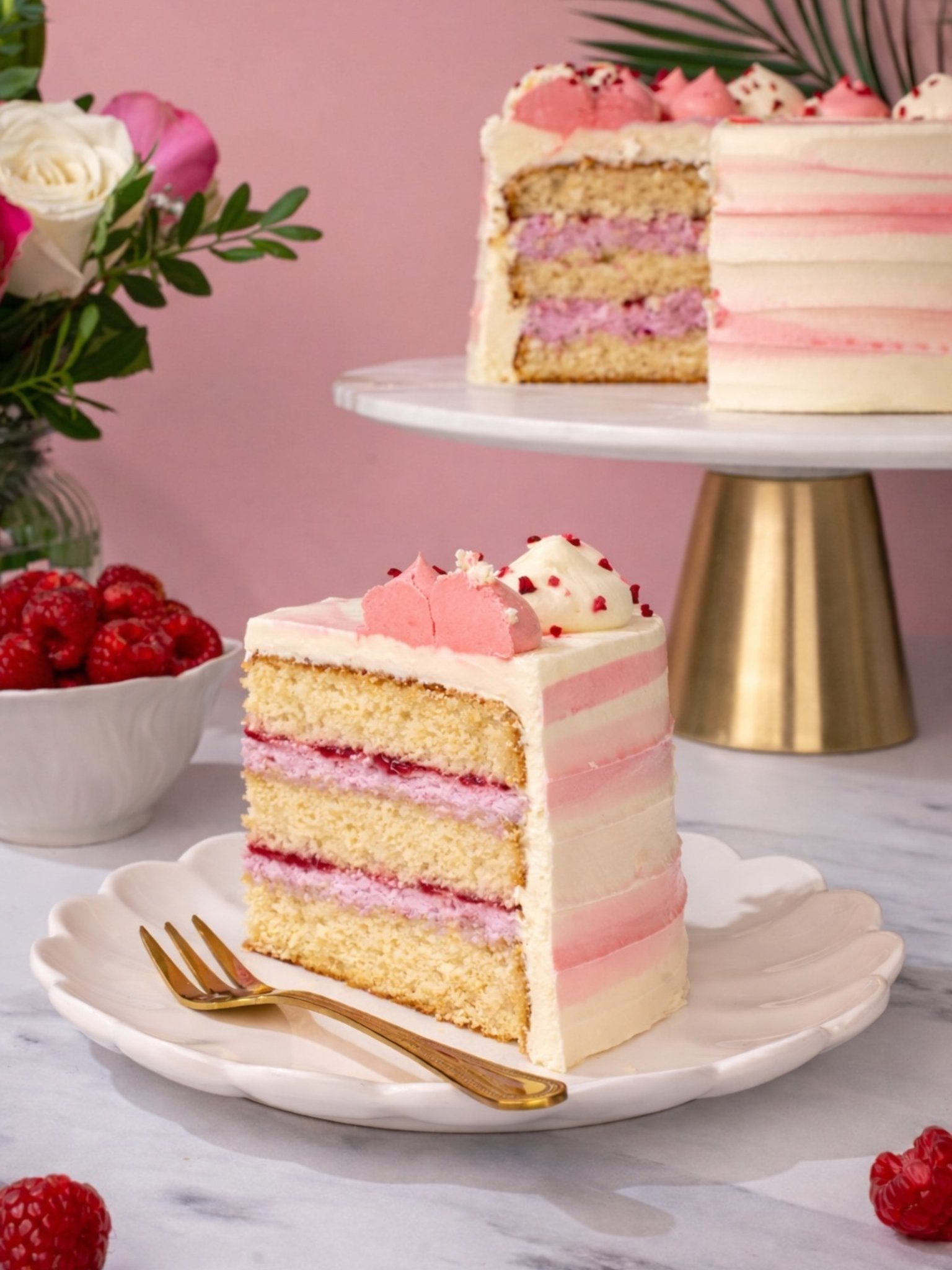 Patisserie Valerie's handmade Ultimate Raspberry Ripple Cake being sliced to reveal raspberry ripple layers